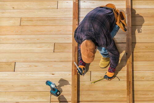 man repairing a deck