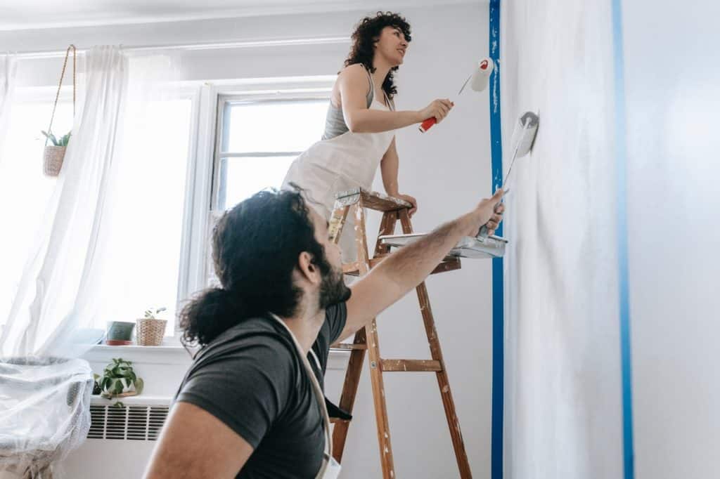 A man and woman painting a room