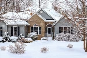A house in snowy conditions with vinyl sidings