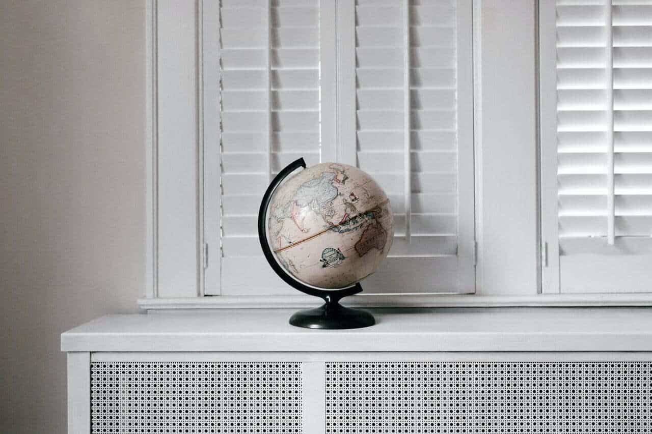 white shutters that just got painted with globe in front
