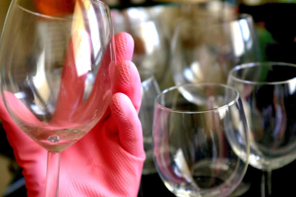 A freshly cleaned glass wearing latex gloves