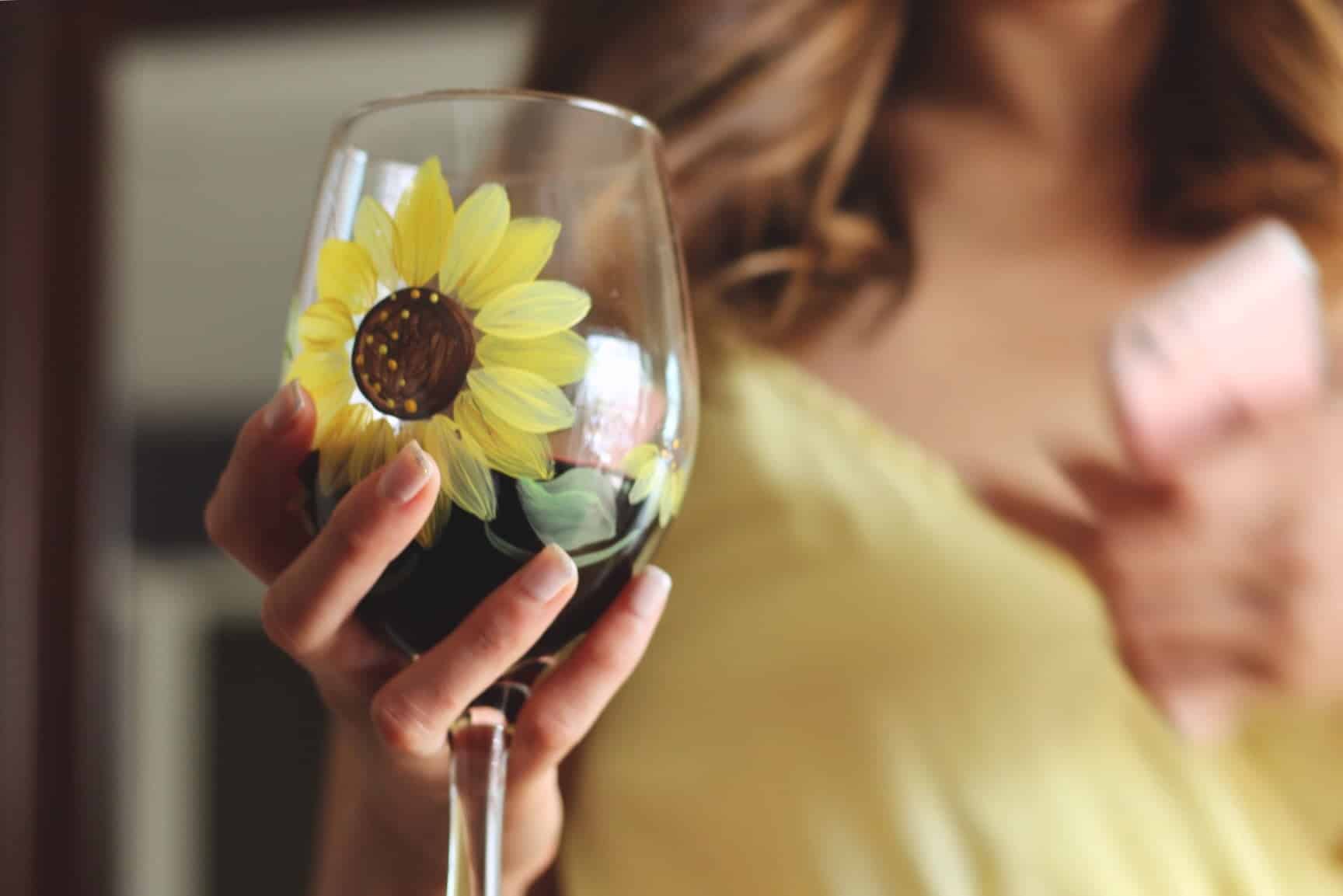 A flower painted on a wine glass
