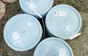 Four five gallon cans of paint, for article difference between interior and exterior paint
