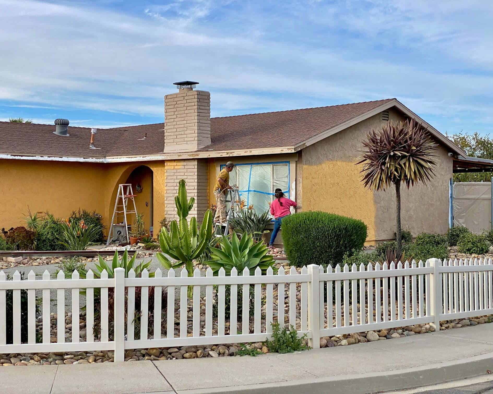 A couple painting their house
